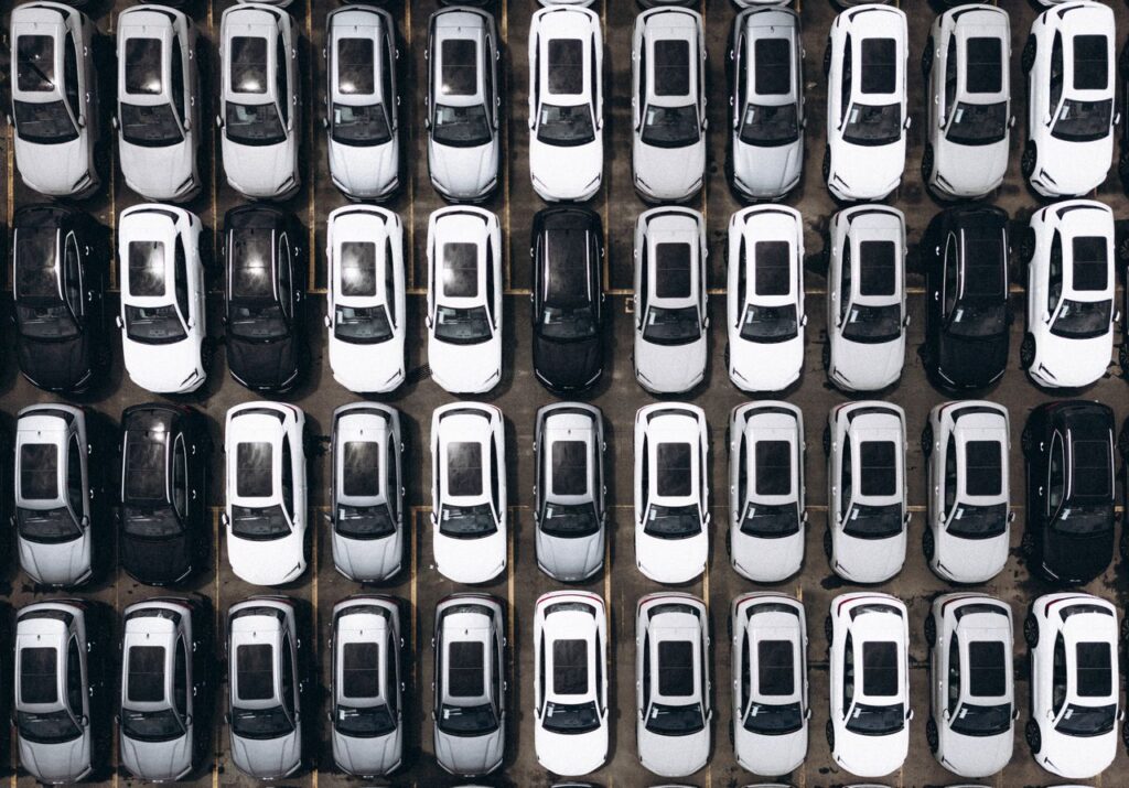 Aerial shot of a parking lot with rows of parked cars in Brazil, showcasing organization and modernity.